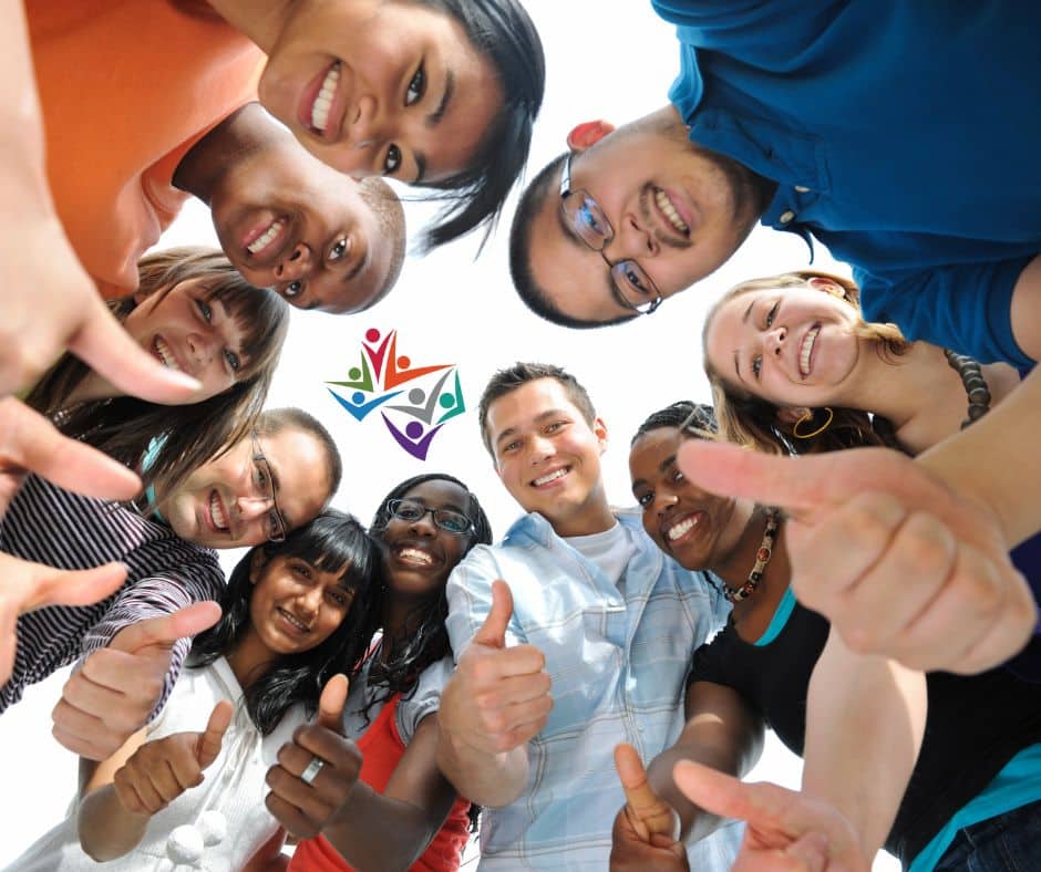 Youth and adults standing in a circle together.